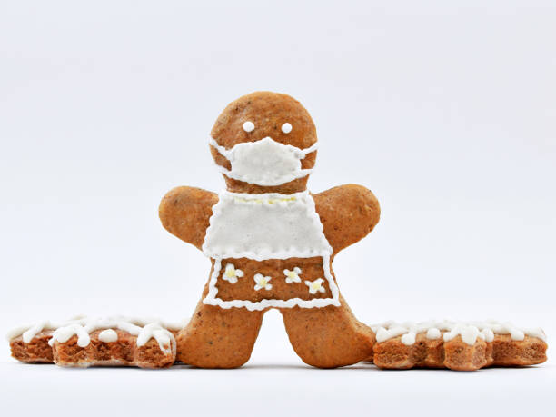 istock Cute gingerbread woman with protective face mask 1870061514