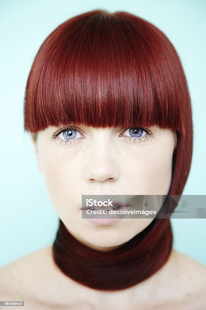 Beautiful red head woman Portrait of a beautiful young woman with dark red hair and blue eyes. Adult Stock Photo