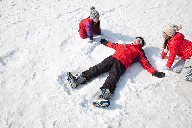 istock Family Playing in the Snow, Father Making Snow-Angel 187006821