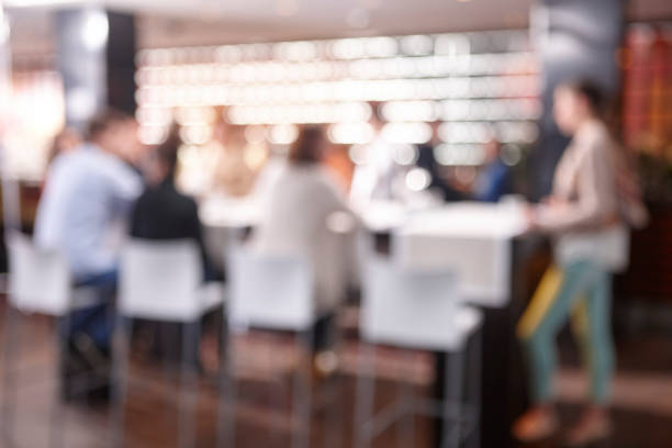 istock Out of focus effect. Restaurant interior with people. Seated persons 1870075150