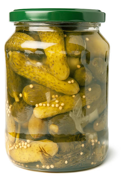 istock Cucumbers in glass jar on white background 187007813