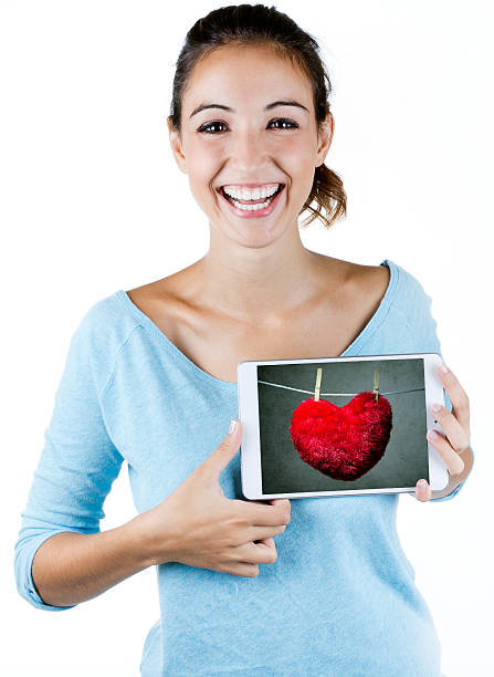 istock Happy woman holding one digital tablet with a heart 187008562