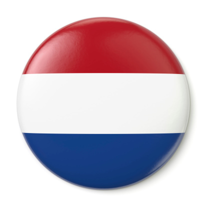 A pin button with the flag of the Kingdom of the Netherlands. Isolated on white background with clipping path.