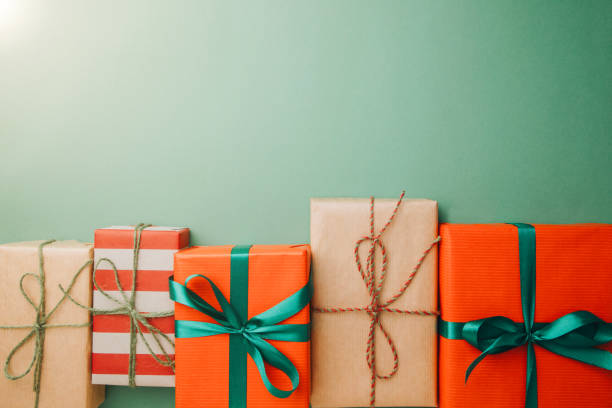 Christmas background. Gifts wrapping in red and brown paper on a green background stock photo