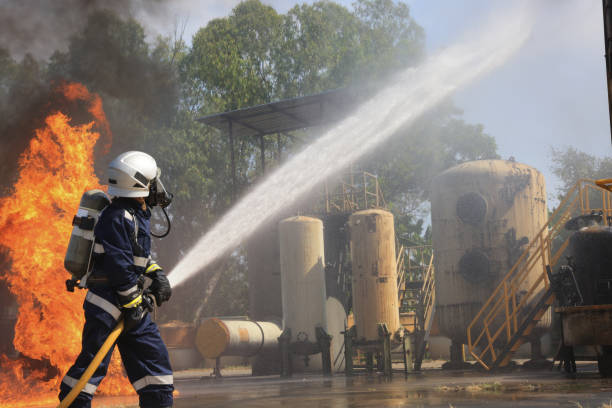 Fireman keeping an eye on the smoke and fire in the background.See my 911 Emergency Lightbox...