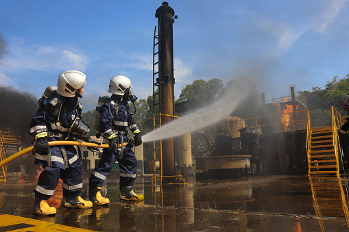 Female Rescue Fire fighter practice extinguishing