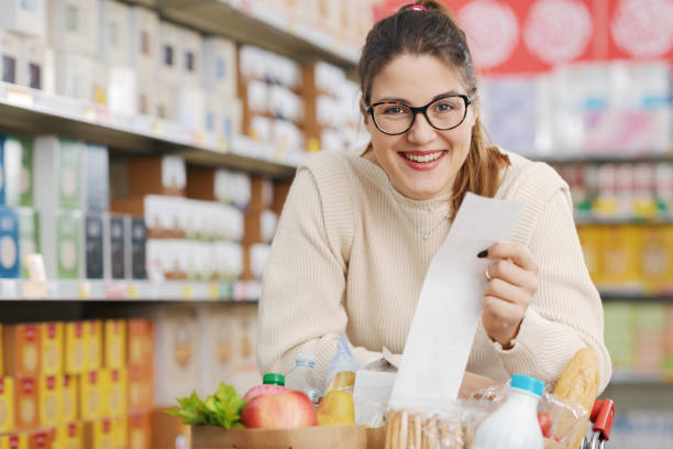 istock Happy customer holding a long grocery receipt 1870132402