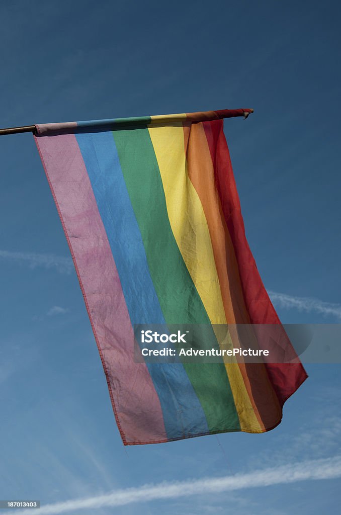 Rainbow flag in blue sky rainbow flag is the symbol for the gays. Blue Stock Photo