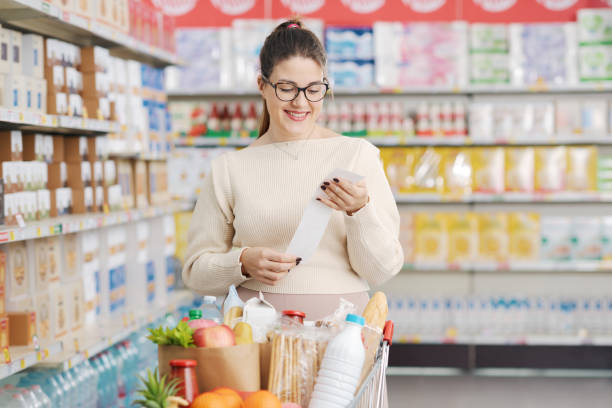 istock Happy customer holding a long grocery receipt 1870135562