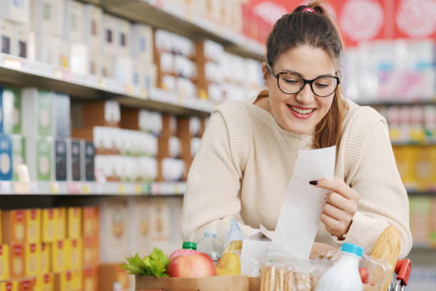 istock Happy customer holding a long grocery receipt 1870143353