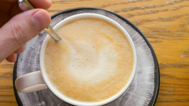 istock Hand stirs coffee foam spoon, energy. process preparing coffee, energizing effect beverage. stirring moment anticipation energy boost coffee provides, daily ritual powers many people's mornings. 1870143863