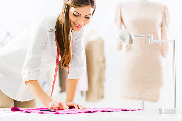 istock Smiling female tailor at work. 187015370