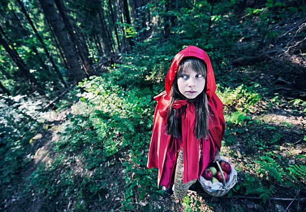 Scared Little Red Riding Hood in the forest.