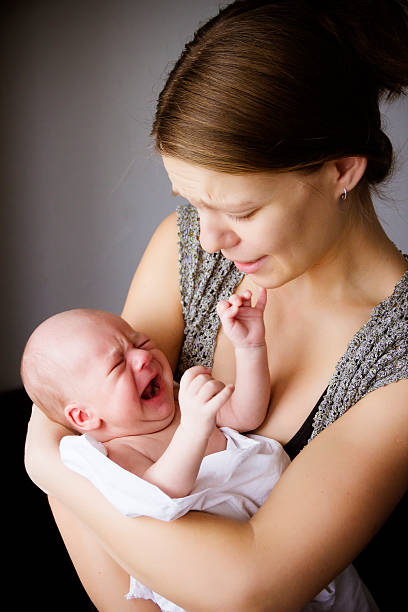 mother and the baby cry together stock photo