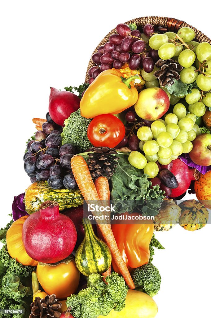 Thanksgiving cornucopia with fruit and vegetables isolated on white A beautiful and elaborate Thanksgiving cornucopia with fruits and vegetables isolated on white.  rr Abundance Stock Photo