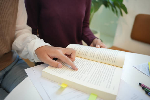 istock Learning with friends Young students campusHigh School Tutor for examining helps school homework together withÂ friend catching up and learning 1870171905