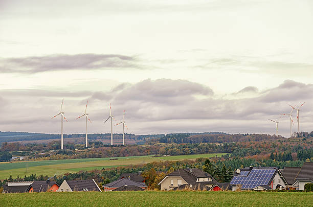istock Wind turbines behind village in valley 187017254