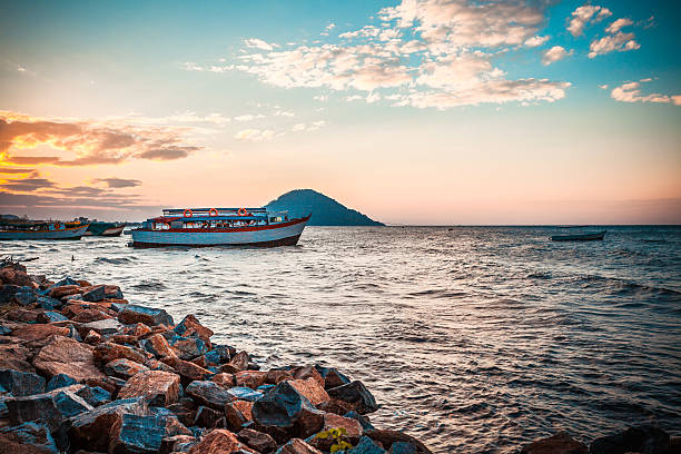 Beautiful view of the Malawi lake with a ship in the water Relaxing sunset over the Malawi lake malawi stock pictures, royalty-free photos & images