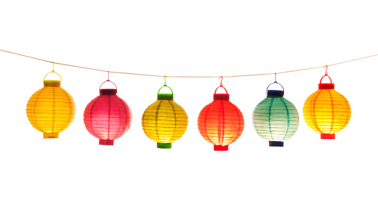 Subject: A row of Chinese lanterns in various color hanging on a string. Isolated on white background.