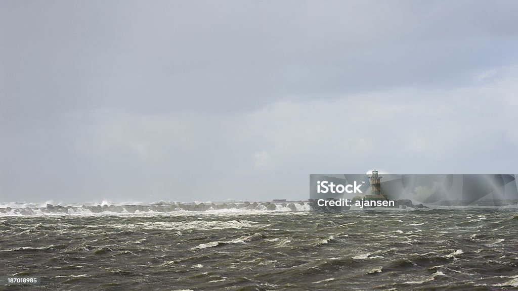 very rough sea splashing lighthouse during a storm Beach Stock Photo