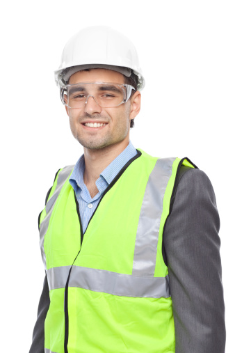 Smiling construction worker, wearing traffic safety uniform,protective eyewear and white hard hat. Isolated over white background.