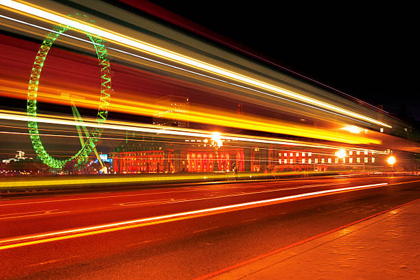 Tail Light Pattern in Night London A bus streaks past the London Eye and County Hall, image taken from Westminster Bridge, London, UK, #iStockalypse. london county hall stock pictures, royalty-free photos & images