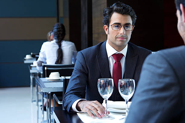istock Two smiling business men have dinner at restaurant 187019735
