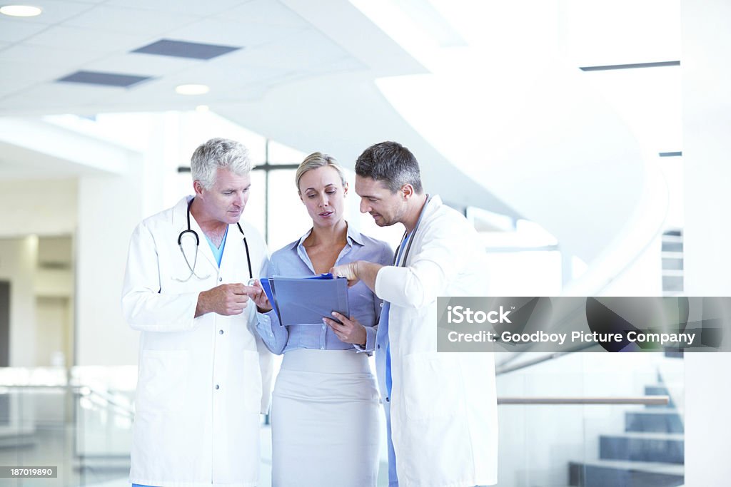 Reaching a mutual diagnosis A group of hospital staff having an impromptu meeting together Administrator Stock Photo