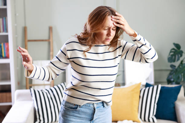 istock Young woman suffering from vertigo or dizziness problem of brain or inner ear 1870216238