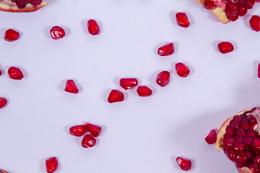 A fresh pomegranate seeds isolated on white background