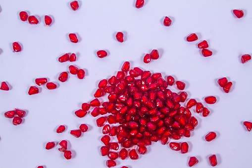 A fresh pomegranate seeds isolated on white background