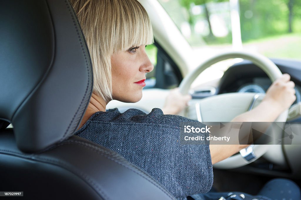 attractive woman driver in her car attractive blond woman driver in her car Adult Stock Photo