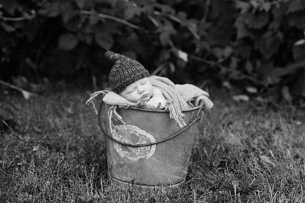 istock Newborn Boy Sleeping in Bucket Outside 187022021