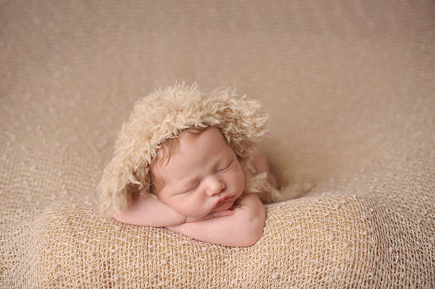 istock Newborn Boy Sleeping in Fuzzy Knit Hat 187022028