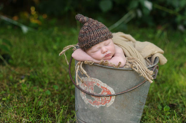 istock Newborn Boy Sleeping in Bucket 187022122