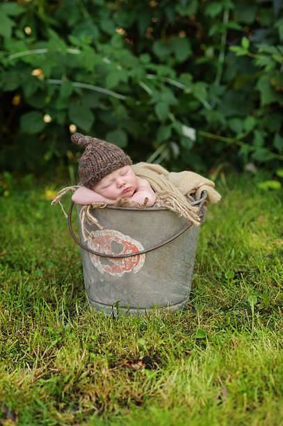 istock Newborn Boy Sleeping in Bucket 187022132