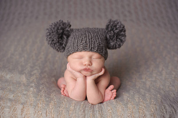 istock Newborn Boy Sleeping in Knit Hat 187022195