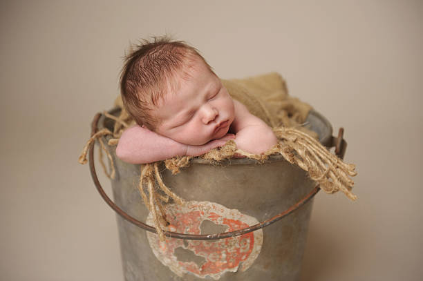 istock Newborn Boy Sleeping in Bucket 187022246