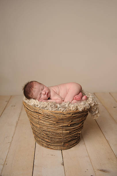 istock Newborn Boy Sleeping in Basket 187022267