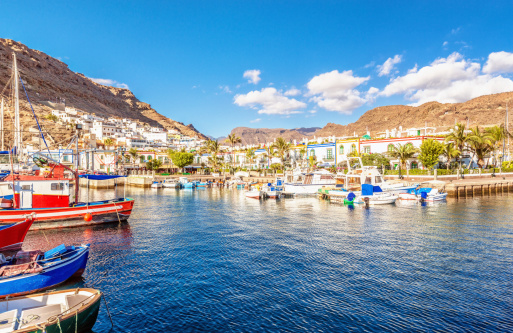 Fishing boats, harbour and colorful houses at the beautiful town of Puerto de Mogan, Gran Canaria