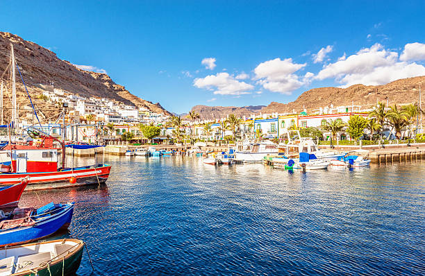 Port of Mogan - Gran Canaria Fishing boats, harbour and colorful houses at the beautiful town of Puerto de Mogan, Gran Canaria grand canary stock pictures, royalty-free photos & images