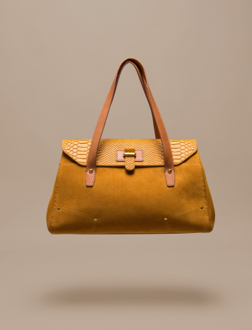 Women handbag on brown background