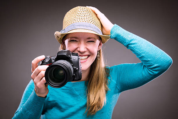 istock Happy woman with a camera 187023119