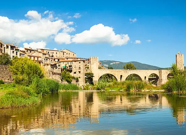 Small mediewal town with romanesque bridge over the Fluvià river (Catalonia, Spain).
