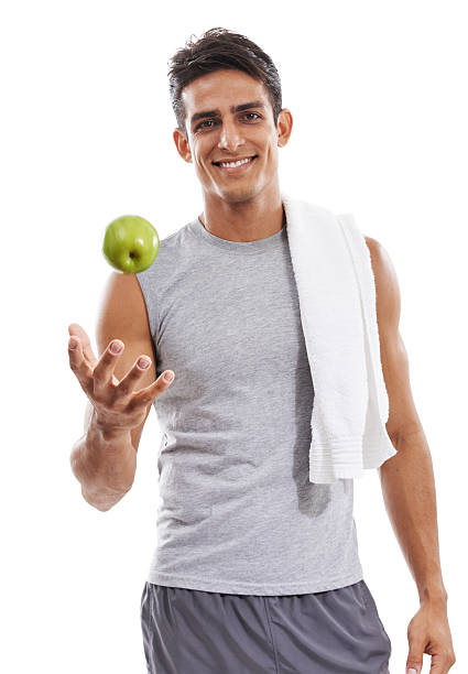 una manzana después de una ardua sesión de entrenamiento - brown hair isolated on white short hair young men fotografías e imágenes de stock