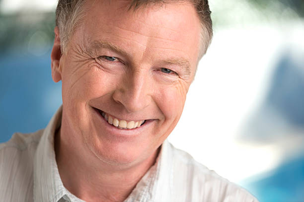 istock smiling older man with out of focus background 187025104