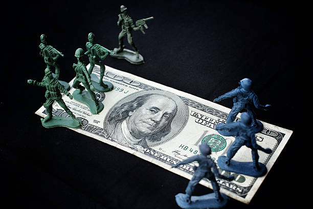 istock toy soldier standing with dollar 187025307