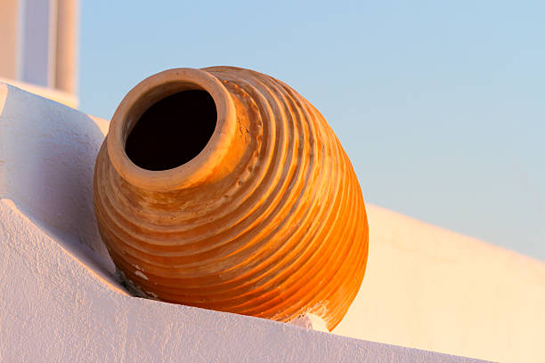 White villa house in Oia with a flower pot, Santorini