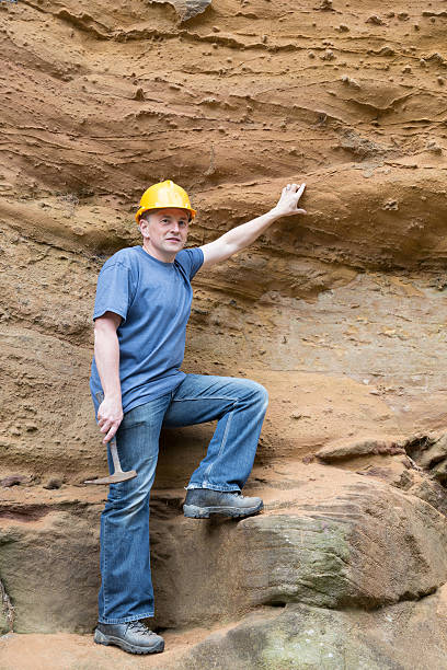 istock male geologist examining sandstone 187025941