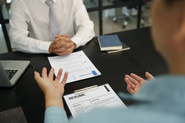 istock Team leader coach teach young workers explain on paper for business plan listen talkative coworker and discussing new project presentation Serious professional advisor consultingÂ in office 1870259475